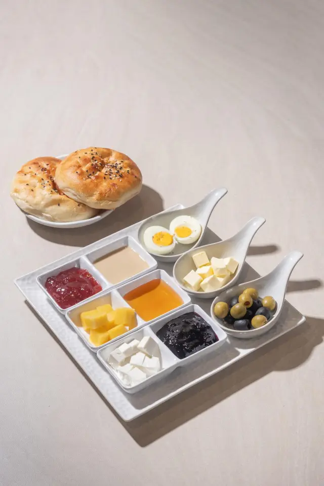Turkish breakfast plate for one with cheeses, olives, eggs, jams and fresh bread